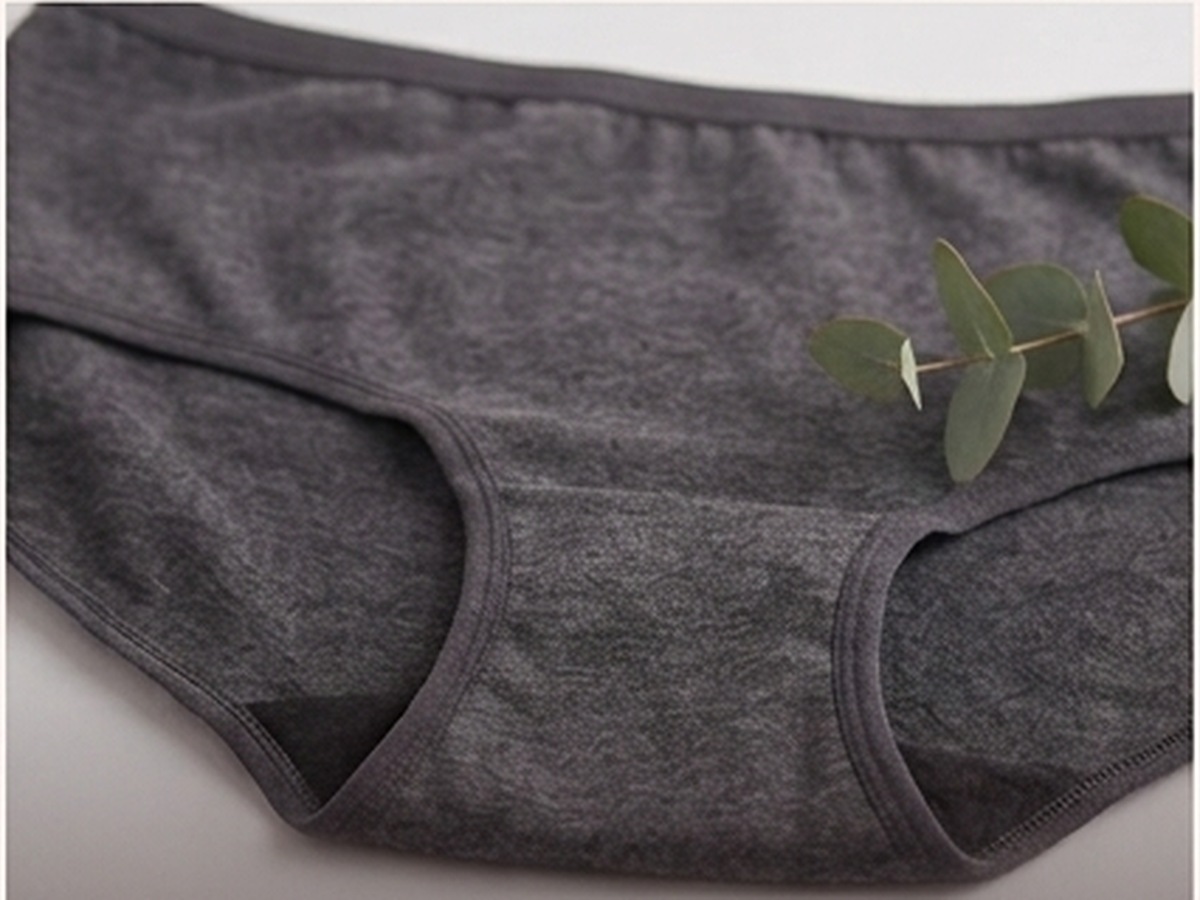Charcoal Teusy period brief flat-lay with eucalyptus
